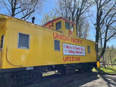 Yellow Union Pacific Railroad caboose on the grounds of Depot Park