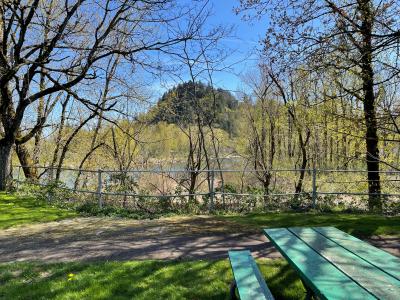 Green picnic table at Depot Park overlooking Beaver Creek and the Sandy River with a view of Broughton Bluff.